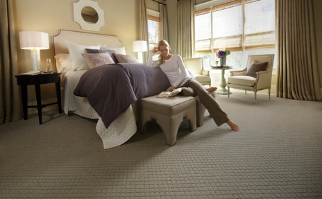 Woman reading on Karastan carpet